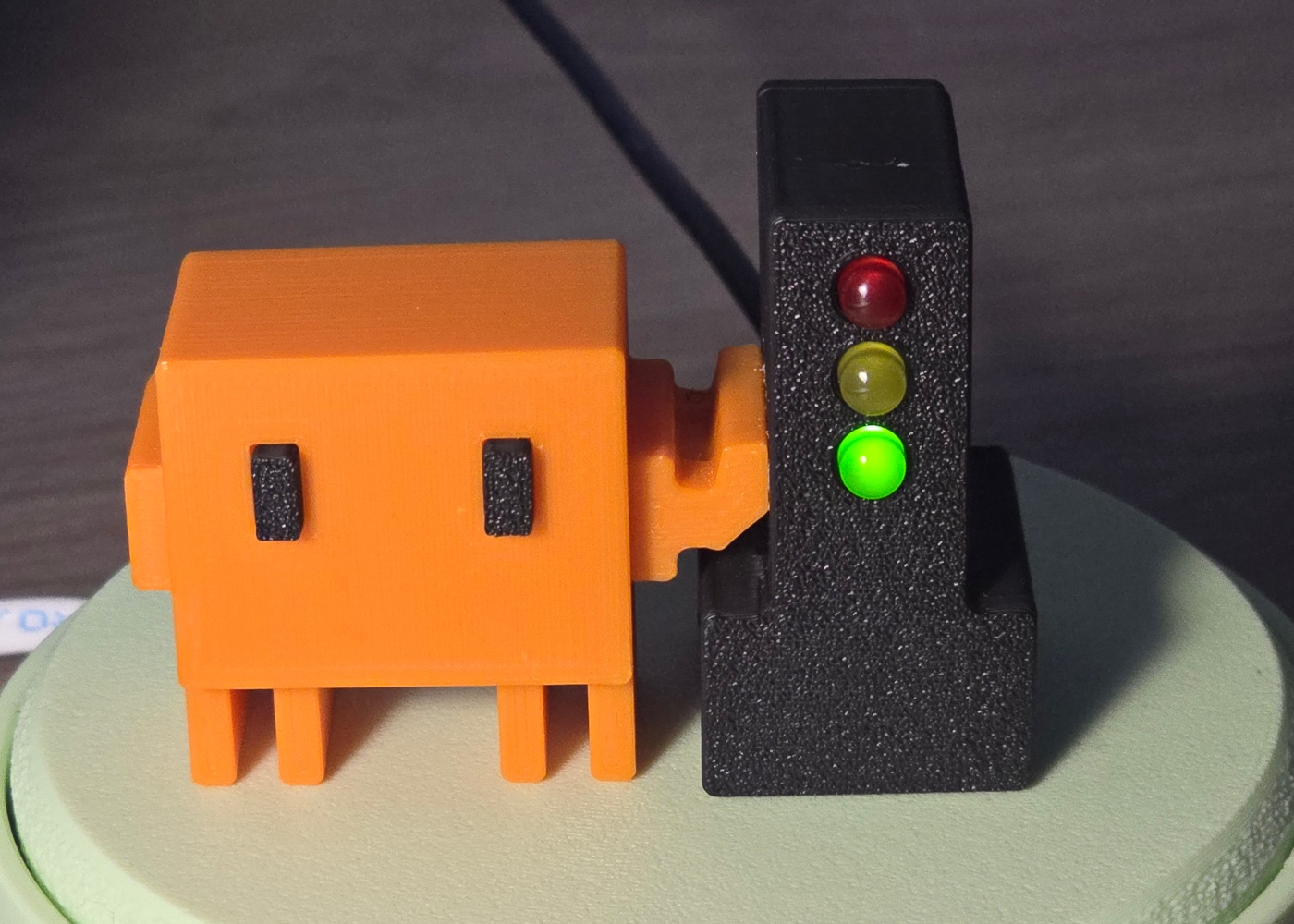 Photo of the BroGlow lamp: the orange mascot beside the black traffic light